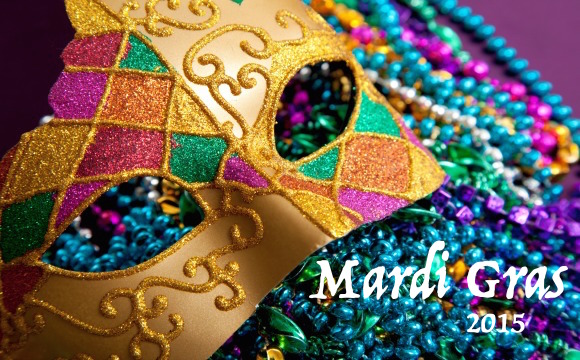Gold mardi gras mask and beads